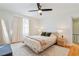 Bright bedroom with ceiling fan, hardwood floors, large windows, and a comfortable bed for a relaxing retreat at 4060 Haverhill Ne Dr # F, Atlanta, GA 30342