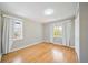 Well-lit bedroom features hardwood floors, neutral walls, and natural light streaming through two windows at 4060 Haverhill Ne Dr # F, Atlanta, GA 30342