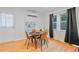 Cozy dining room featuring a round wooden table with modern chairs and stylish window treatments at 4060 Haverhill Ne Dr # F, Atlanta, GA 30342