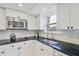 Kitchen with black granite counters, stainless steel microwave and faucet, and white cabinets at 4060 Haverhill Ne Dr # F, Atlanta, GA 30342