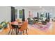 Bright living room with a wooden dining set, large window, and an olive green couch on a colorful rug at 4060 Haverhill Ne Dr # F, Atlanta, GA 30342