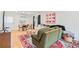 Bright and airy living space with comfortable olive green seating, a colorful rug, and stylish decor at 4060 Haverhill Ne Dr # F, Atlanta, GA 30342