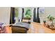 Sunlit living area featuring a cozy chaise lounge, large windows, and a stylish bar cart at 4060 Haverhill Ne Dr # F, Atlanta, GA 30342