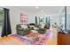 Bright living room featuring a large green sectional sofa and a colorful area rug on hardwood floors at 4060 Haverhill Ne Dr # F, Atlanta, GA 30342