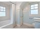Bright bathroom featuring a tiled shower/tub, black and white tiled floor, and built in storage at 509 Ponce De Leon Pl, Decatur, GA 30030
