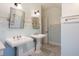 Bright bathroom featuring dual pedestal sinks and patterned tile flooring at 509 Ponce De Leon Pl, Decatur, GA 30030
