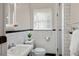 Clean bathroom featuring subway tile, white fixtures, and modern design elements at 509 Ponce De Leon Pl, Decatur, GA 30030