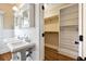Elegant bathroom featuring dual sinks, a spacious walk-in closet, and hardwood flooring at 509 Ponce De Leon Pl, Decatur, GA 30030