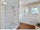 Bathroom featuring a glass enclosed shower, tiled walls and hardwood floors at 509 Ponce De Leon Pl, Decatur, GA 30030
