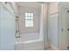 Well-lit bathroom featuring a bathtub with shower and a privacy window at 509 Ponce De Leon Pl, Decatur, GA 30030