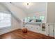 Bright bedroom with built-in daybed, drawers, shelves, and hardwood flooring at 509 Ponce De Leon Pl, Decatur, GA 30030