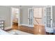 View from the bedroom features a hallway and staircase through open french doors and wood floors at 509 Ponce De Leon Pl, Decatur, GA 30030