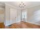 Neutral bedroom with hardwood floors, large window, and classic white trim at 509 Ponce De Leon Pl, Decatur, GA 30030