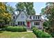 Charming two-story home with a red door, mature trees and manicured landscaping at 509 Ponce De Leon Pl, Decatur, GA 30030
