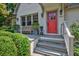 Inviting home entrance with a red front door, stone steps, and lush landscaping at 509 Ponce De Leon Pl, Decatur, GA 30030