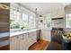 Charming kitchen featuring custom cabinets, stainless steel appliances, subway tile backsplash, and a farmhouse sink at 509 Ponce De Leon Pl, Decatur, GA 30030