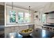 Sunlit kitchen with a farmhouse sink, stainless steel appliances, custom cabinets, and stylish pendant lighting at 509 Ponce De Leon Pl, Decatur, GA 30030