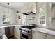 Well-appointed kitchen with a stainless steel range, custom hood, subway tile backsplash, and marble countertops at 509 Ponce De Leon Pl, Decatur, GA 30030