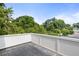 Spacious balcony with gray decking provides a serene outdoor living space surrounded by lush trees at 520 Wabash Ne Ave, Atlanta, GA 30312