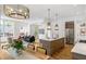 Open-concept living space with a modern kitchen, dining area, and living room with hardwood floors and bright windows at 520 Wabash Ne Ave, Atlanta, GA 30312