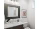 Modern bathroom with a gray vanity, white countertop, updated fixtures, and decorative accents at 520 Wabash Ne Ave # B, Atlanta, GA 30312