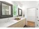 Bright bathroom featuring double sinks, modern fixtures, and a large window for natural light at 520 Wabash Ne Ave # B, Atlanta, GA 30312