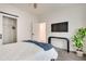 Comfortable bedroom featuring hardwood-style flooring, a sleek TV, and a modern sliding closet door at 520 Wabash Ne Ave # B, Atlanta, GA 30312