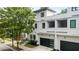 Modern townhouse with clean white siding, black trim, and a two-car garage, showcasing contemporary design at 520 Wabash Ne Ave # B, Atlanta, GA 30312