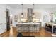 Modern kitchen and dining area with island seating, stainless steel appliances and a dining table near the window at 520 Wabash Ne Ave # B, Atlanta, GA 30312