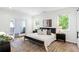 Bright main bedroom with hardwood floors, natural light, modern furnishings, and a balcony at 520 Wabash Ne Ave # B, Atlanta, GA 30312