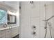 Elegant walk-in shower with modern fixtures and white tile, complemented by a view into the spacious bathroom at 520 Wabash Ne Ave # B, Atlanta, GA 30312
