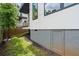 Narrow side yard with a gray storage door leading to the basement, providing additional storage space at 520 Wabash Ne Ave # B, Atlanta, GA 30312