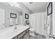 Bright bathroom with patterned tile floor, large mirror, shower with curtain, and modern fixtures at 1914 Lakeshore Overlook Nw Cir, Kennesaw, GA 30152