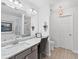 Bathroom featuring a granite countertop, a bathtub, a shower, and a large mirror at 1914 Lakeshore Overlook Nw Cir, Kennesaw, GA 30152
