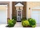 Charming townhome featuring well-maintained landscaping and an attached one-car garage at 1914 Lakeshore Overlook Nw Cir, Kennesaw, GA 30152