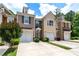 Exterior shot of townhomes showing a well maintained community with garage parking and manicured landscaping at 1914 Lakeshore Overlook Nw Cir, Kennesaw, GA 30152