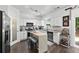 Bright kitchen features white cabinets, stainless appliances, a large island, and dark hardwood floors at 1914 Lakeshore Overlook Nw Cir, Kennesaw, GA 30152