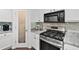 A close-up of a well-equipped kitchen showcasing granite countertops and stainless-steel appliances and a pantry at 1914 Lakeshore Overlook Nw Cir, Kennesaw, GA 30152