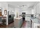 Well-lit kitchen with stainless steel appliances, an island, granite countertops, and white cabinets at 1914 Lakeshore Overlook Nw Cir, Kennesaw, GA 30152