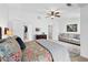 Spacious bedroom with a sitting area, ceiling fan, closet, and large bed with decorative pillows at 1914 Lakeshore Overlook Nw Cir, Kennesaw, GA 30152