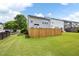 Expansive lawn is enclosed by a wooden fence, offering privacy and a safe play area at 212 Regent Sq, Woodstock, GA 30188