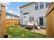 Private fenced backyard with a lush lawn, patio, and inviting swing chair to enjoy the outdoors at 212 Regent Sq, Woodstock, GA 30188