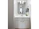 Bathroom featuring a single sink, white cabinets, and framed mirror at 212 Regent Sq, Woodstock, GA 30188