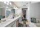Bright bathroom featuring a double vanity and tile flooring, adjacent to the walk-in closet at 212 Regent Sq, Woodstock, GA 30188