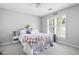Bedroom with neutral walls, white trim, large window and ceiling fan at 212 Regent Sq, Woodstock, GA 30188