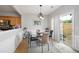 Bright dining area with hardwood floors, stylish light fixture, and a sliding door to the outside at 212 Regent Sq, Woodstock, GA 30188