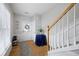 Bright foyer featuring hardwood floors, staircase, and a view of the front door and window at 212 Regent Sq, Woodstock, GA 30188