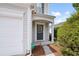 Inviting front entryway with a charming door, wreath, and well-maintained landscaping at 212 Regent Sq, Woodstock, GA 30188