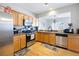 An open kitchen has stainless steel appliances, granite countertops, and hardwood floors at 212 Regent Sq, Woodstock, GA 30188