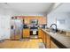 A well-lit kitchen with stainless steel appliances, granite countertops, and wooden cabinets at 212 Regent Sq, Woodstock, GA 30188